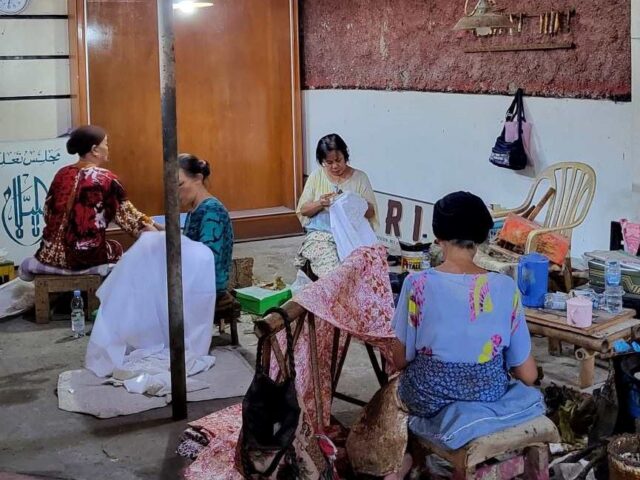 A group of women workers are creating batik